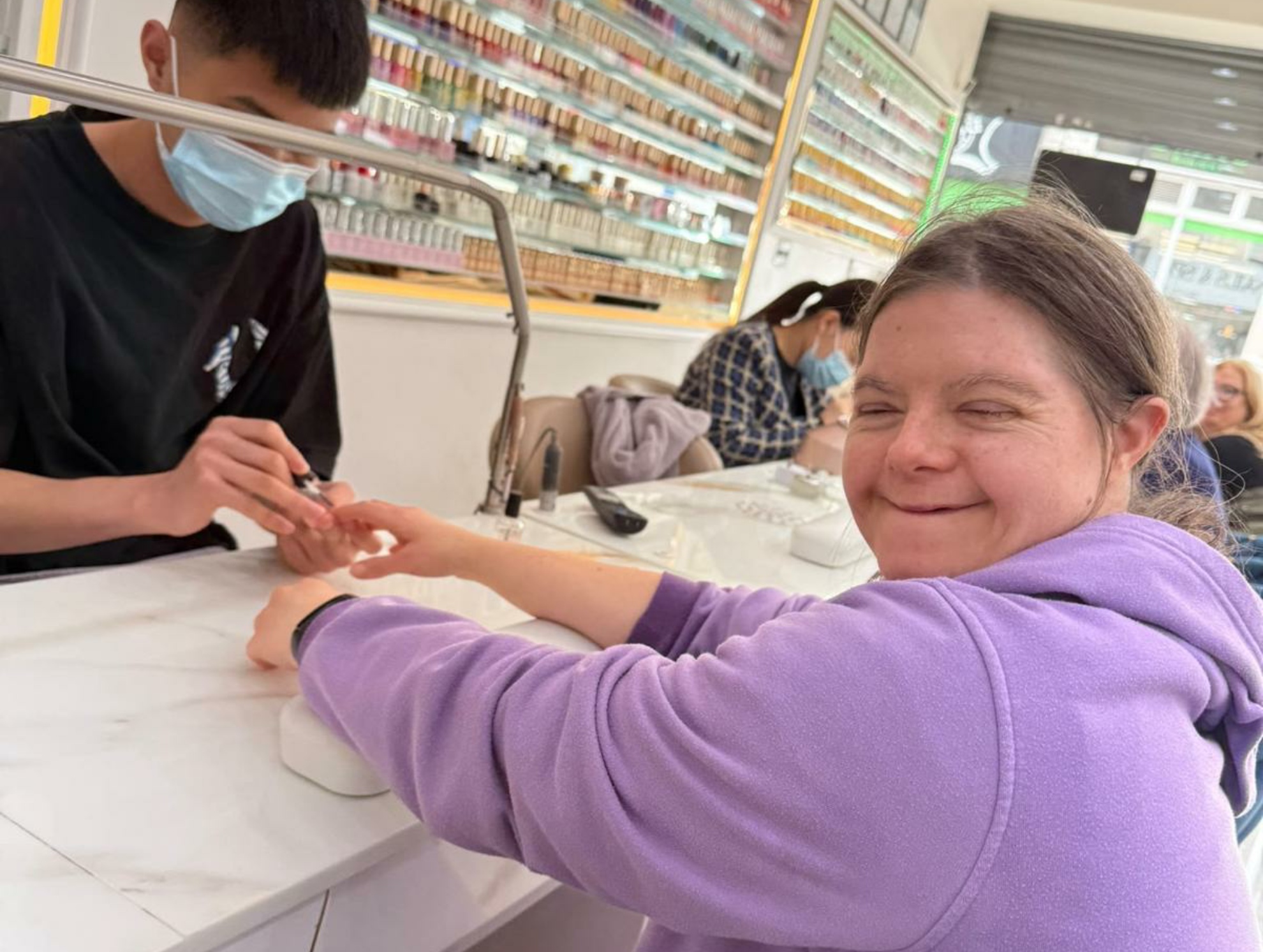 A resident enjoying a manicure at a local salon